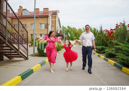 Happy well-dressed family on a walk.  126082584