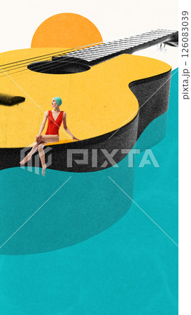 Woman in swimsuit and cap sitting on edge of giant acoustic guitar floating on water. Festival. Woman in swimsuit and cap sitting on edge of giant acoustic guitar floating on water. Festival. 126083039