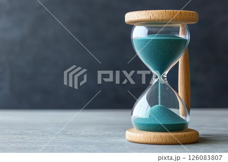 Flowing Sand in Hourglass with Wooden Frame Measuring Time for Countdown and Deadlines 126083807