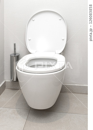 White ceramic toilet bowl with open lid in modern bathroom White ceramic toilet bowl with open lid in modern bathroom 126083858