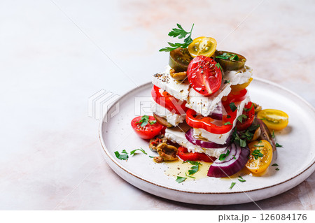 Greek salad stack with feta cheese, tomatoes, red onions and olives. Greek salad stack with feta cheese, tomatoes, red onions and olives. 126084176