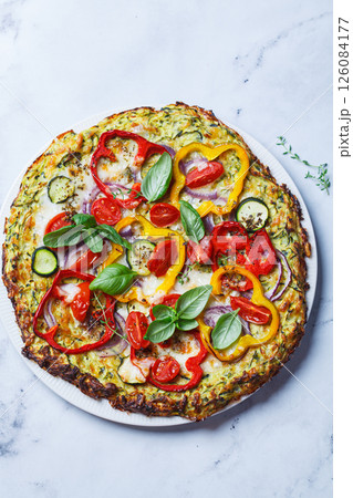 Vegan pizza on zucchini crust with vegetables and mozzarella. Vegan pizza on zucchini crust with vegetables and mozzarella. 126084177