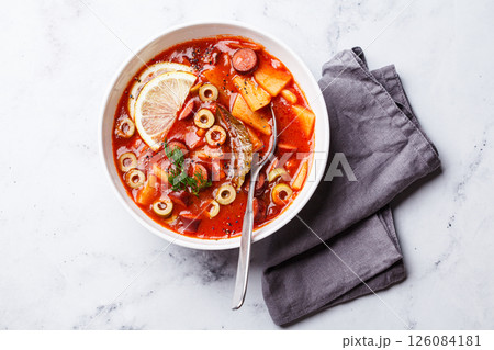 Traditional soup solyanka with smoked sausages, olives and potatoes. 126084181