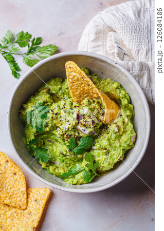 Avocado guacamole spread with nacho corn chips. 126084186