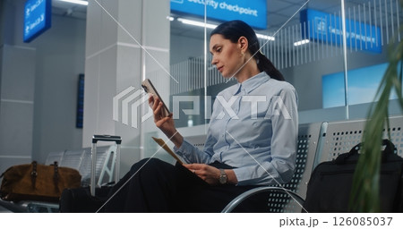 Airport Terminal: Successful Businesswoman Scanning Boarding Pass Using Smartphone 126085037
