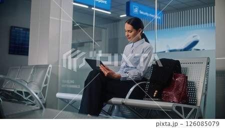 Airport Terminal: Successful Businesswoman Using Digital Tablet, Looking at Camera 126085079
