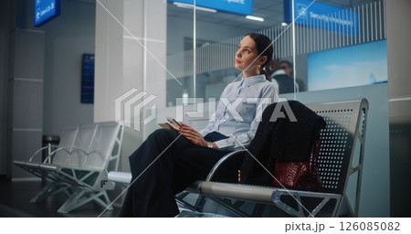 Airport Terminal: Female Entrepreneur Using Smartphone, Doing e-Business, Waiting for Airplane Flight 126085082