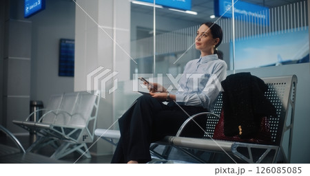 Airport Terminal: Successful Businesswoman with Bag and Documents Using Smartphone 126085085
