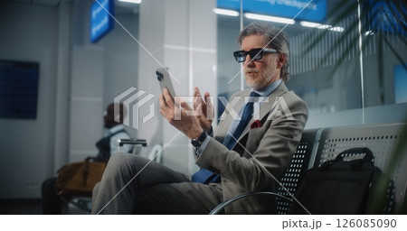 Airport Terminal: Successful Entrepreneur Talking to Investor on Smartphone by Video Chat 126085090