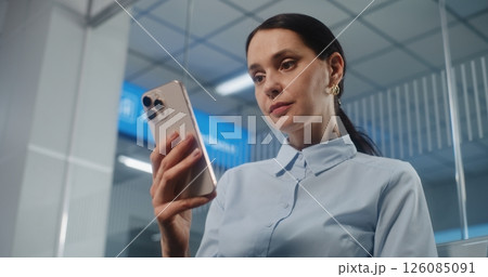Airport Terminal: Businesswoman Scanning Boarding Pass Using Smartphone Airport Terminal: Businesswoman Scanning Boarding Pass Using Smartphone 126085091