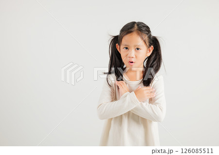 Portrait Asian young kid girl unhappy or confident standing holding two cross arms say no X sign, studio shot isolated white background, Thai kindergarten child pose reject gesture with copy space Portrait Asian young kid girl unhappy or confident standing holding two cross arms say no X sign, studio shot isolated white background, Thai kindergarten child pose reject gesture with copy space 126085511