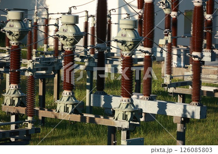 A bunch of power lines are in a field 126085803
