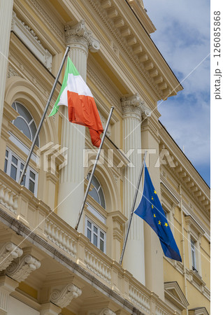 Italian and european union flags waving on government building Italian and european union flags waving on government building 126085868