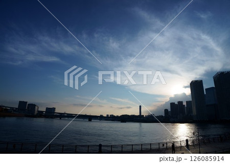 夕暮れ時の水辺のシルエット、空のグラデーションと都市の景色 夕暮れ時の水辺のシルエット、空のグラデーションと都市の景色 126085914