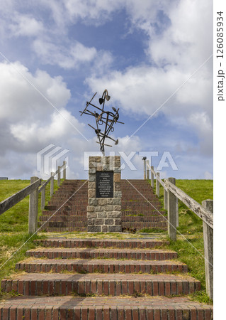 Monument with farming tools rising above brick stairs in Wierum, Friesland, Netherlands 126085934