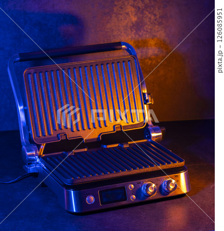 Electric grill radiating warm light creating cozy atmosphere in modern kitchen 126085951