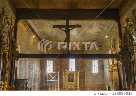 Interior view of the wooden gothic church with Jesus Christ on the cross hanging from the ceiling Interior view of the wooden gothic church with Jesus Christ on the cross hanging from the ceiling 126086039