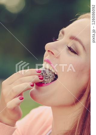 Woman with liitle cookie cupcake. Woman with liitle cookie cupcake. 126086092