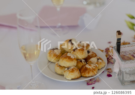 Wedding reception sweet table with traditional czech buns called kolache and champagne glasses 126086395