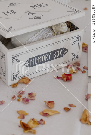 White memory box for wedding with dried rose petals containing lace and fabric decorations White memory box for wedding with dried rose petals containing lace and fabric decorations 126086397