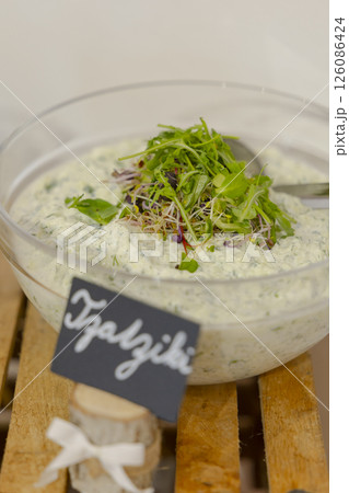 Tzatziki sauce decorated with fresh sprouts in glass bowl 126086424