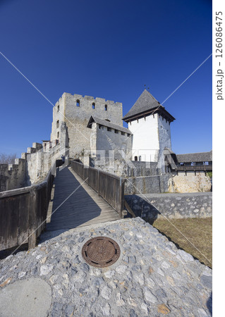 Stone castle with wooden bridge under clear blue sky Stone castle with wooden bridge under clear blue sky 126086475
