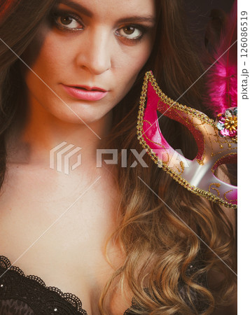 Closeup woman face with carnival mask on dark Closeup woman face with carnival mask on dark 126086519