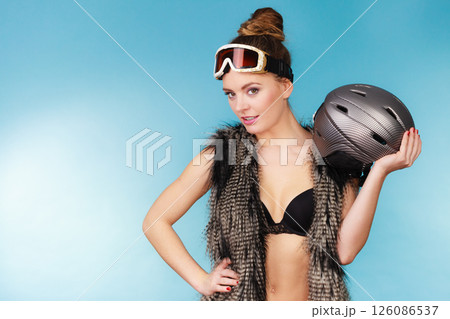Woman seductive girl in ski googles holds helmet Woman seductive girl in ski googles holds helmet 126086537