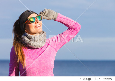 Woman resting after doing sports outdoors on cold day Woman resting after doing sports outdoors on cold day 126086669