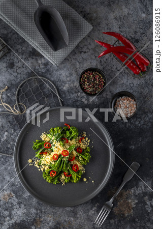 Delicious gourmet dish of roasted broccoli and couscous seasoned with chili pepper 126086915