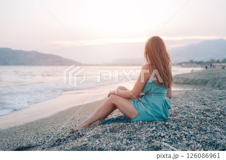 Woman in Flowing Dress on Seaside Pier 126086961