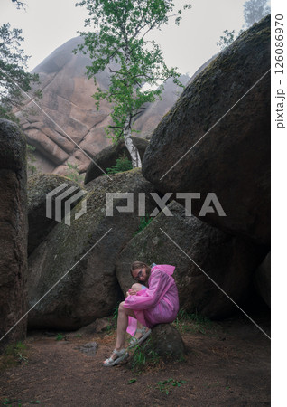 Woman in the taiga forest and rocks of the Stolby nature reserve park Woman in the taiga forest and rocks of the Stolby nature reserve park 126086970
