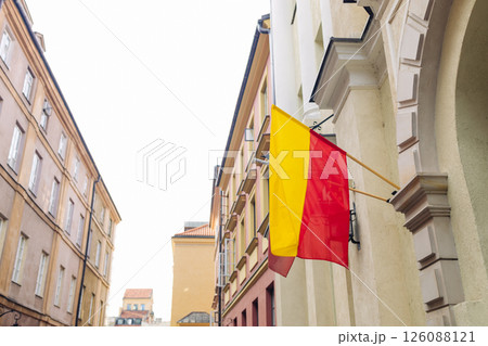 Warsaw city flag hanging on building in Old Town 126088121