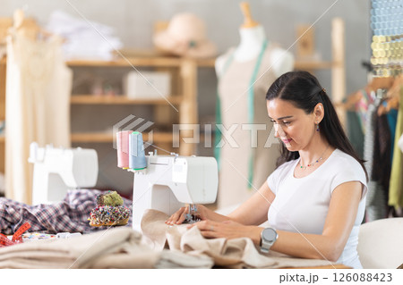 Woman tailor sews clothes in sewing machine 126088423