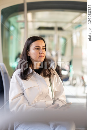 Portrait of middle aged woman in tram car. Trip in urban transport Portrait of middle aged woman in tram car. Trip in urban transport 126088522