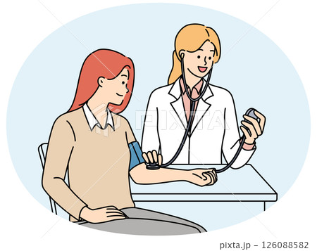 Woman undergoes medical examination at doctor using device for measuring pressure 126088582