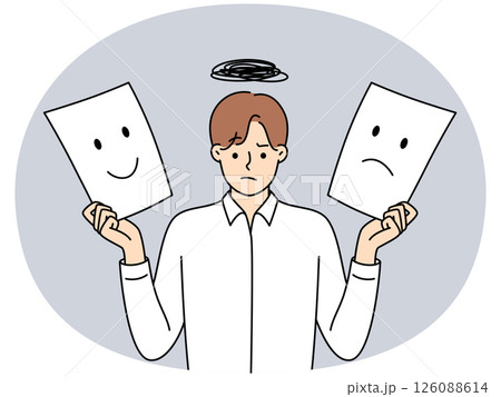 Man holds two sheets of paper with different emotions symbolizing mood swings 126088614
