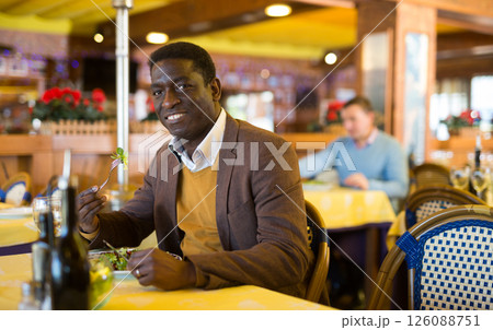 African american man having lunch at restaurant 126088751