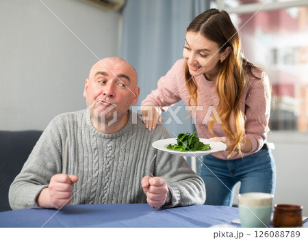 Man dissatisfied by dinner made by his wife Man dissatisfied by dinner made by his wife 126088789