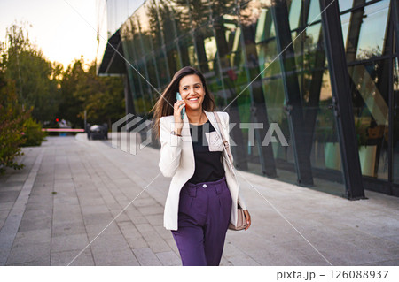Businesswoman talking on a phone after work 126088937