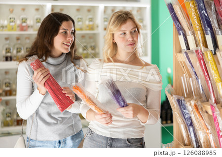 Girl friends client chooses aroma sticks, inhales fragrance Girl friends client chooses aroma sticks, inhales fragrance 126088985