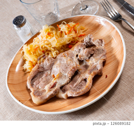 Delicious pork steak with sauerkraut, served on platter Delicious pork steak with sauerkraut, served on platter 126089182