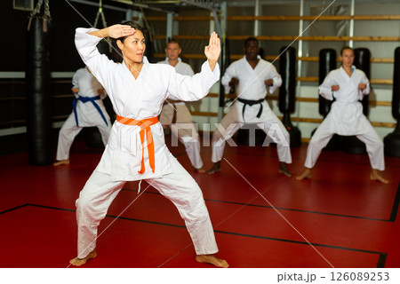 Woman in kimono standing in fight stance in gym 126089253