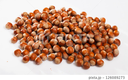 Heap of raw hazelnuts on white Heap of raw hazelnuts on white 126089273