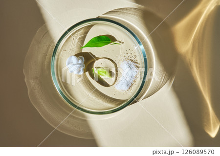A swatch with textures of several skin care products in a petri dish on a beige background. A swatch with textures of several skin care products in a petri dish on a beige background. 126089570
