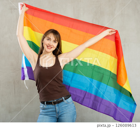 Young happy pretty woman displaying lgbt pride flag 126089613