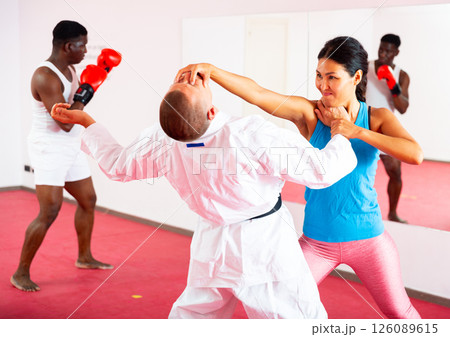People training martial arts in gym People training martial arts in gym 126089615