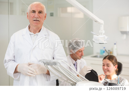 Senior man doctor is standing in dental office, clinic 126089719