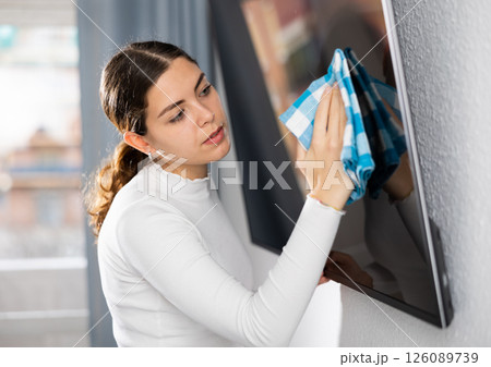 Woman washing TV monitor during cleanup Woman washing TV monitor during cleanup 126089739