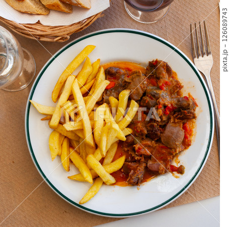 Chicken gizzards in vegetables salsa with fried potatoes Chicken gizzards in vegetables salsa with fried potatoes 126089743